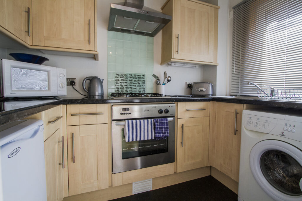 small kitchen area with washing machine