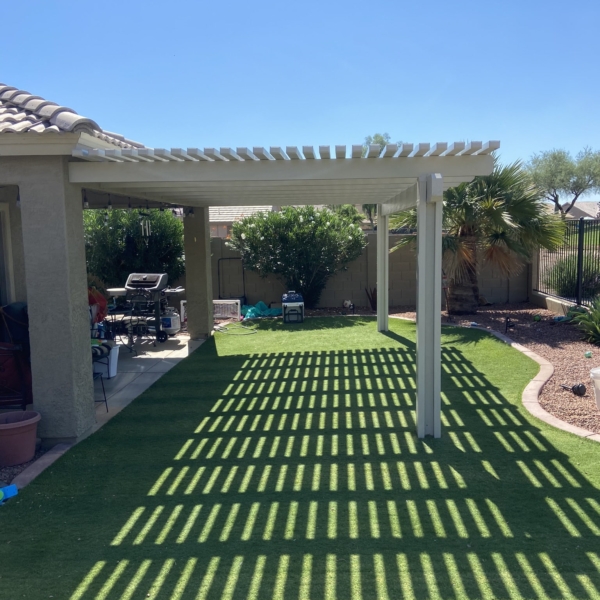 Backyard white lattice pergola installed on turf in Mesa, AZ